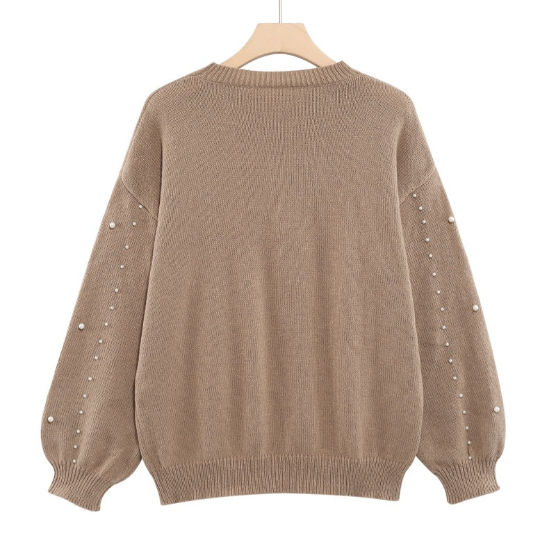 Pull femme à perles et manches bouffantes